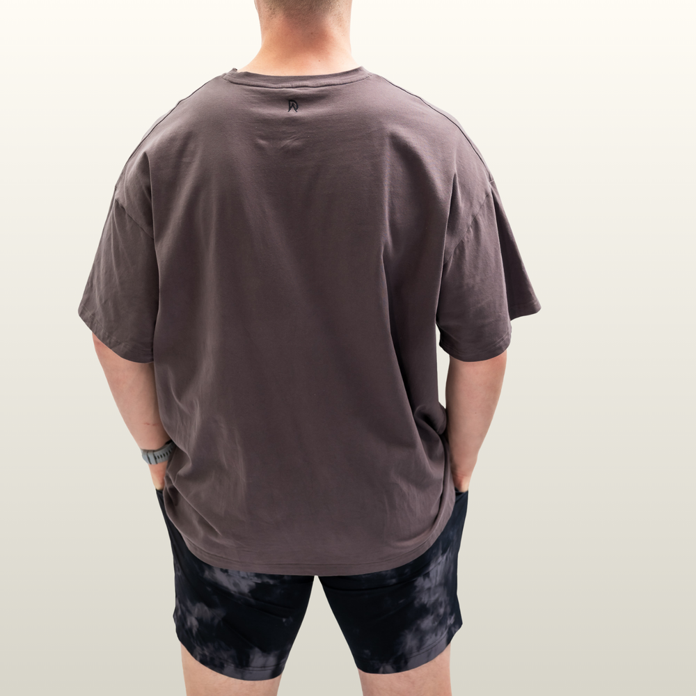 Man wearing the storm grey Endure Oversized Tee, back view
