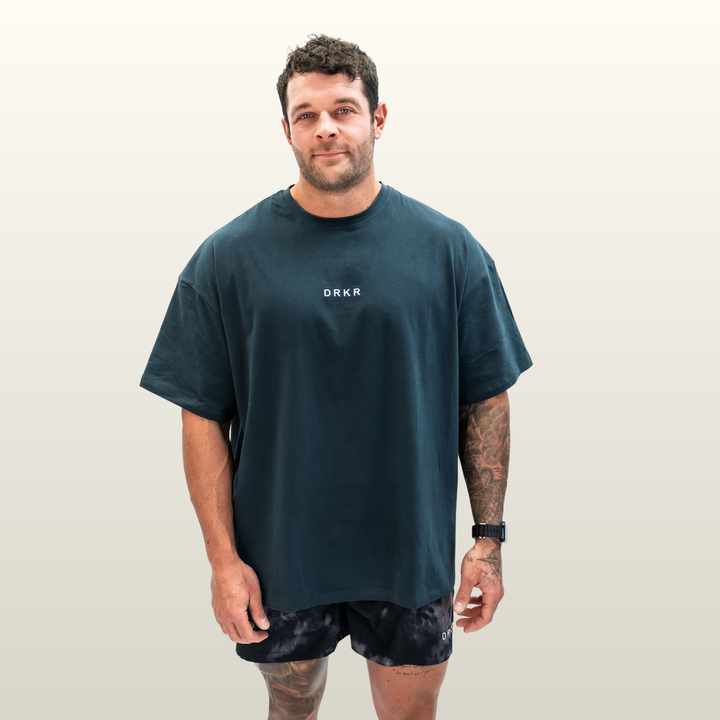 Man wearing the forest green Endure Oversized Tee, front view