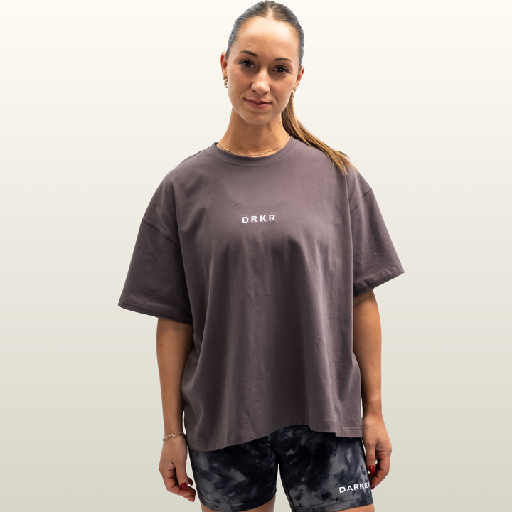 Woman wearing the storm grey Endure Oversized Tee, front view