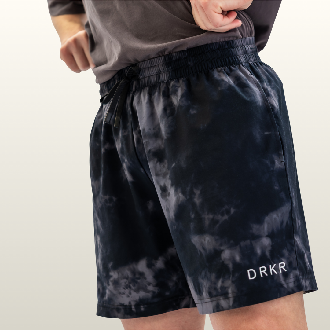 Close-up of the Endure 7 inch Shorts in midnight camo showing the drawstring and DRKR leg logo