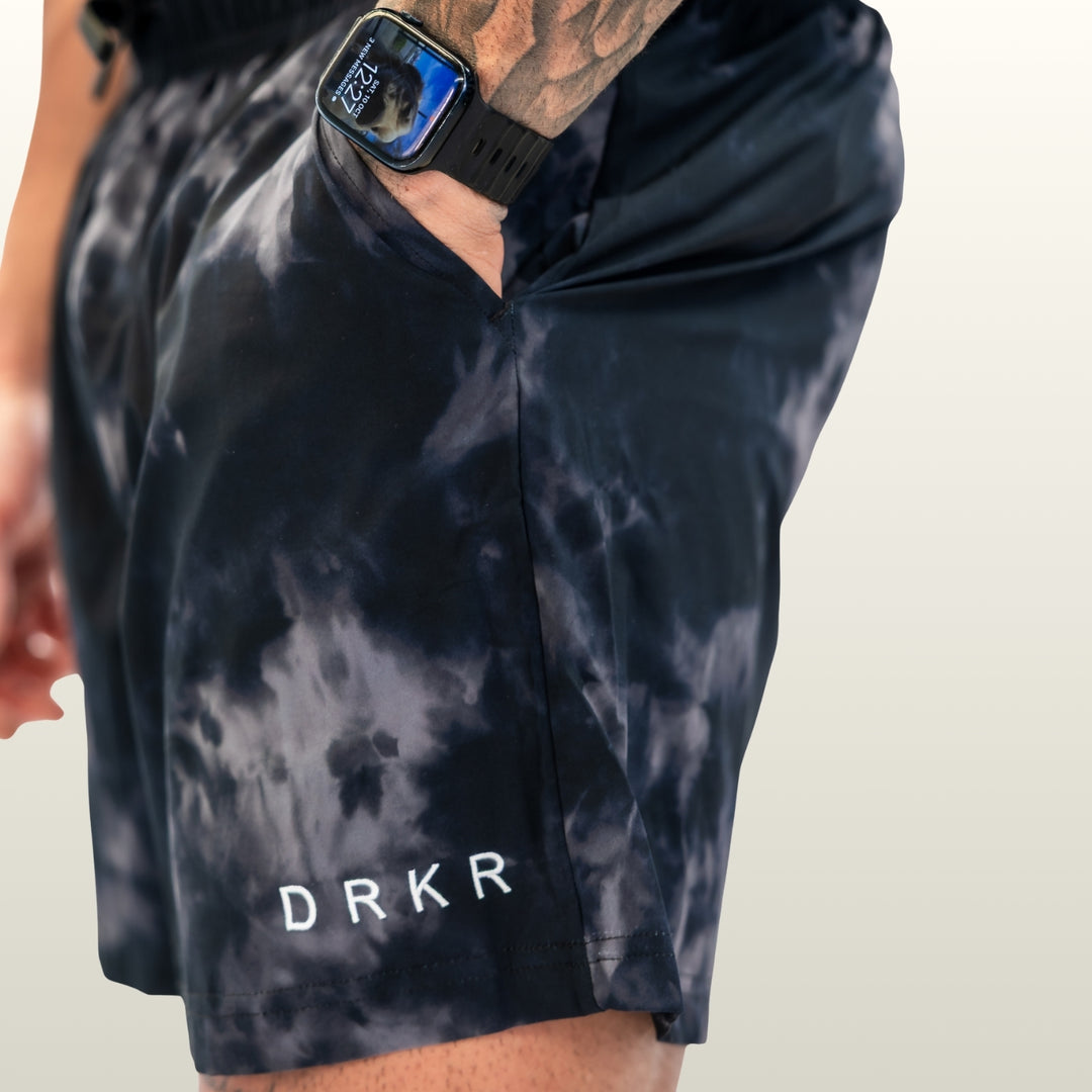 Close-up of the side pocket and DRKR leg logo on the midnight camo Endure 5 inch Shorts