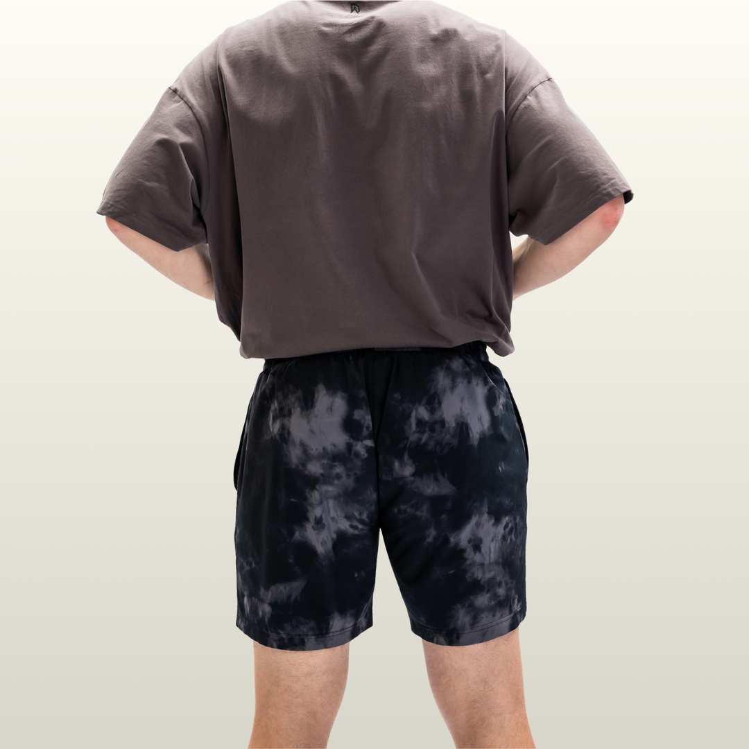 Man wearing the midnight camo Endure 7 inch Shorts, back view