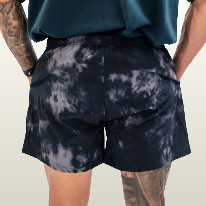Man wearing the midnight camo Endure 5 inch Shorts, back view