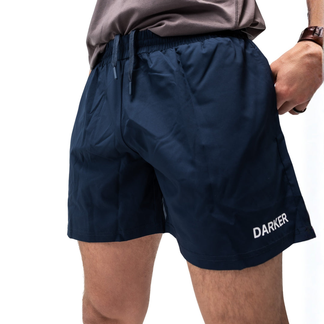 Agile Navy shorts with 'DARKER' branding on a white background