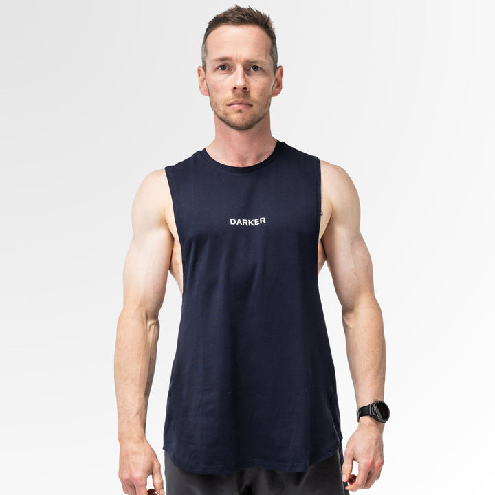 Man wearing a navy tank with 'DARKER' logo on a white background