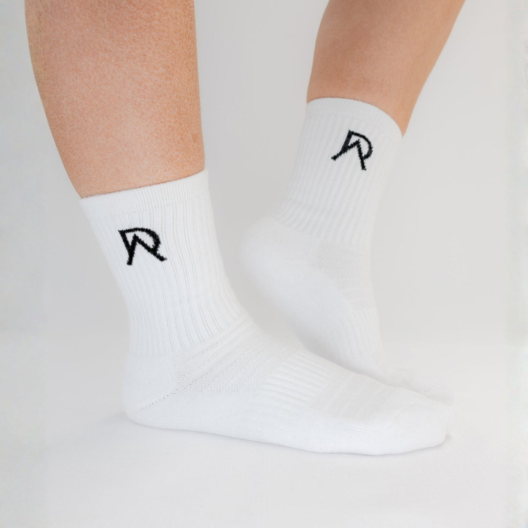 White Agile Crew Socks from the Workout Sock Bundle showing the ankle logo and cushioned sole